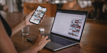 Odzyskiwanie zdjęć z smartfonu i laptopa. Jedno urządzenie w ręce a drugi na stole.